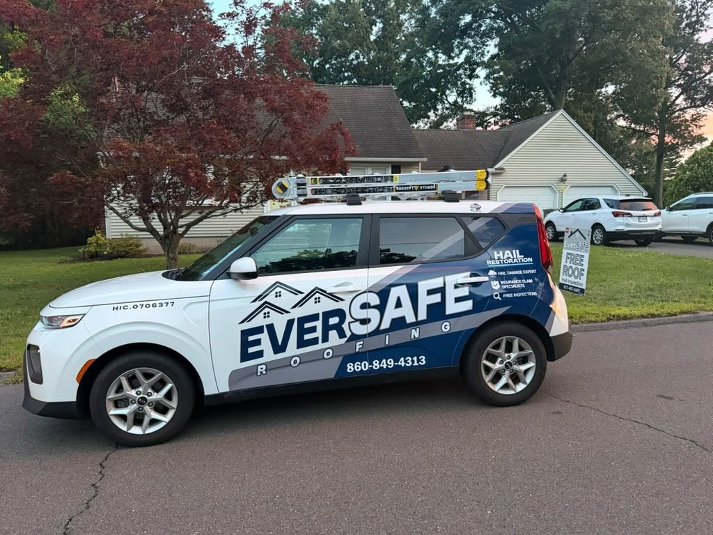 Eversafe Roofing vehicle wrapped with the company name, hail restoration services and Connecticut licence number, parked outside a customer's home