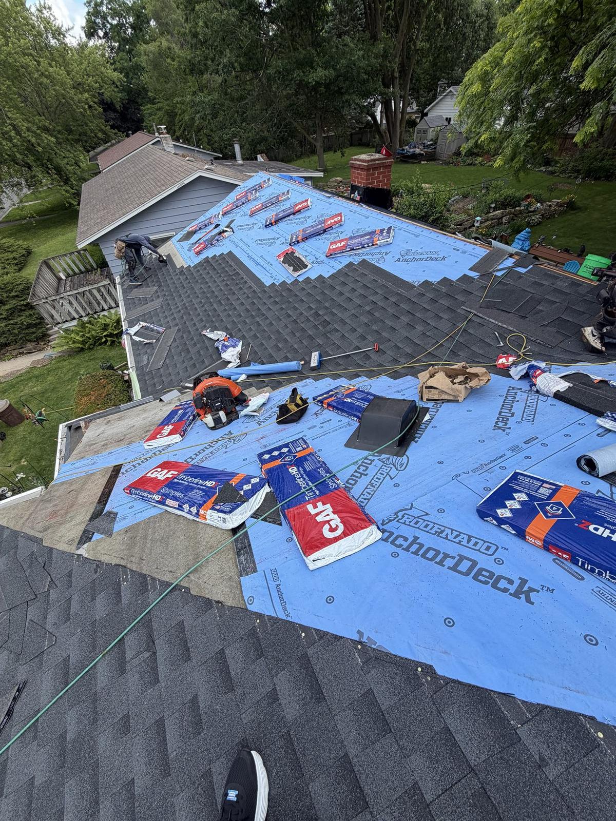 Eversafe Roofing crew installing synthetic underlayment and GAF Timberline architectural shingles